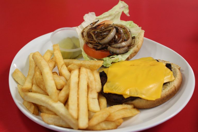 Freshly grilled burger with melted cheese and a side of crispy fries, available at Fun Zone.