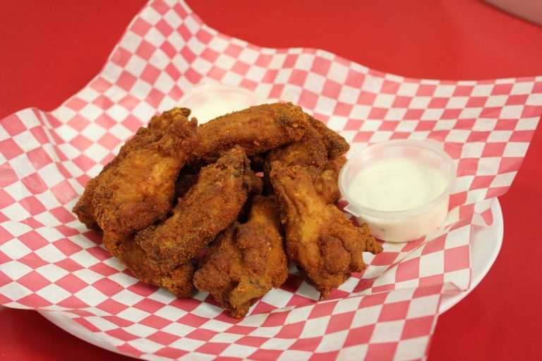 Hot and spicy wings served at Fun Zone Skate Center Café, perfect for guests looking for a savory snack.