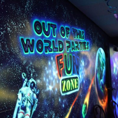 Fun Zone Skate Center’s cosmic party room, designed with glowing stars, planets, and neon colors to create a fun atmosphere.